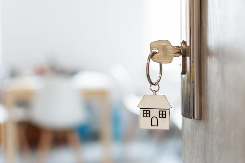 House key on keychain in door lock