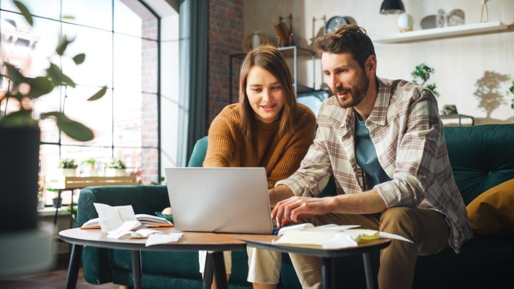 Couple on laptop together in home